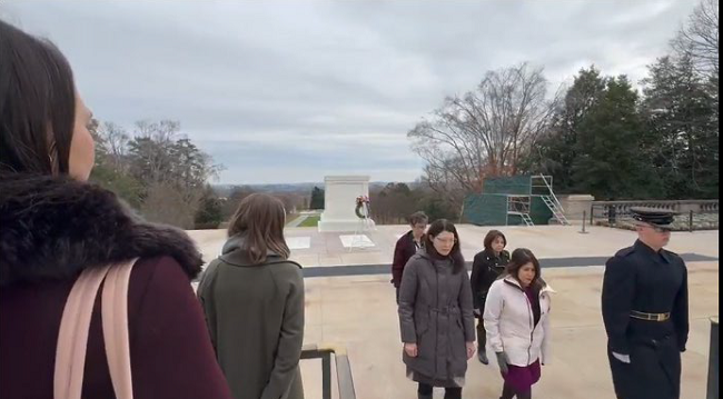 A guard leads (in the front, L to R) Rachel Ramoni and Susan Kirsh as (in the back, L to R) Carolyn Clancy and Pauline Cilladi-Rehrer follow during a wreath-laying ceremony at the Tomb of the Unknown Soldier. The ceremony concluded with the playing of Taps as some attendees wiped tears from their faces.