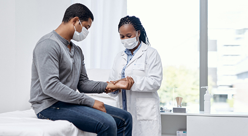  Shot of a doctor checking a patient's pulse