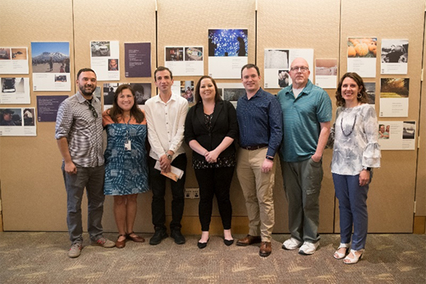 Veteran participant and research project manager Ray Facundo, MSW, with Dr. Ono (first and second from left), Veterans, and caregivers at the Portland exhibit.