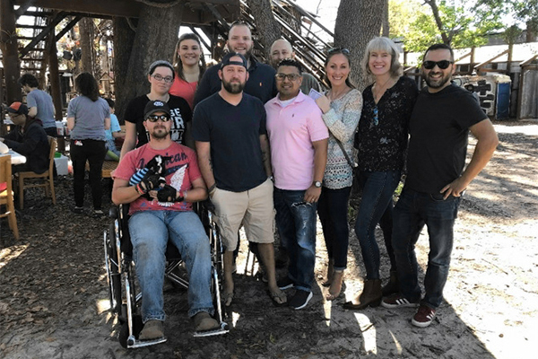 Veterans and caregivers with baby goat (!) and research team Dr. Gala True (second from right) and Mr. Ray Facundo (first to the right) at one of many project-focused events.